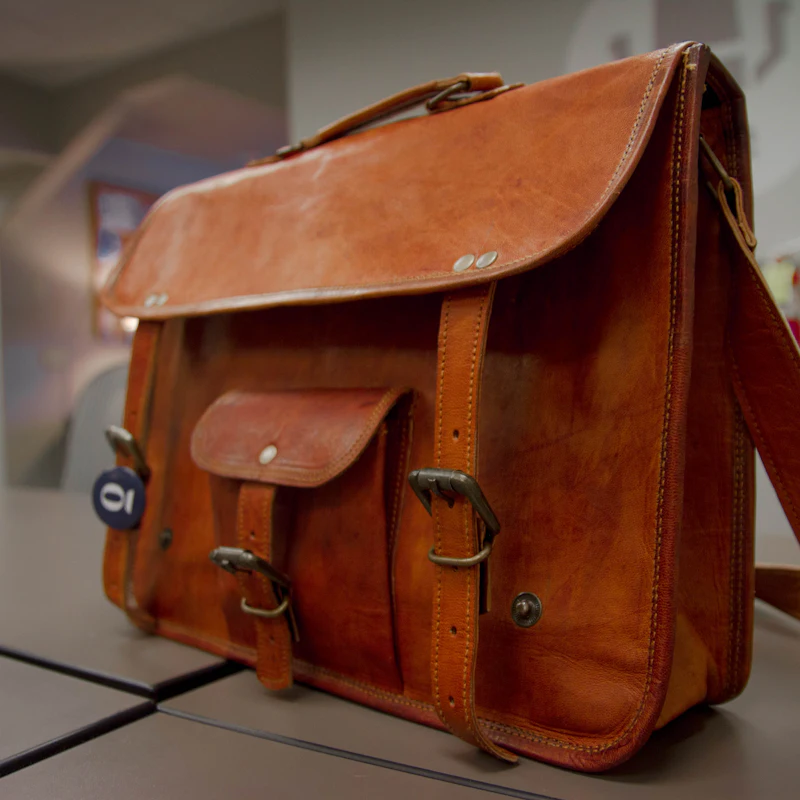Cartable en cuir fauve à poche avant et bandoulière